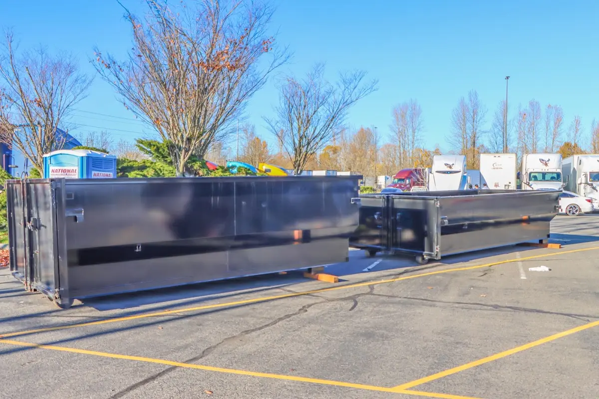 Professional dumpster rental service with roll-off container on residential driveway in Algoma